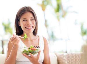 happy-woman-eating-salad-